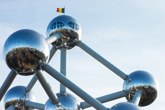 The Atomium in Brussels, a striking modern architectural landmark with metallic spheres under a blue sky.